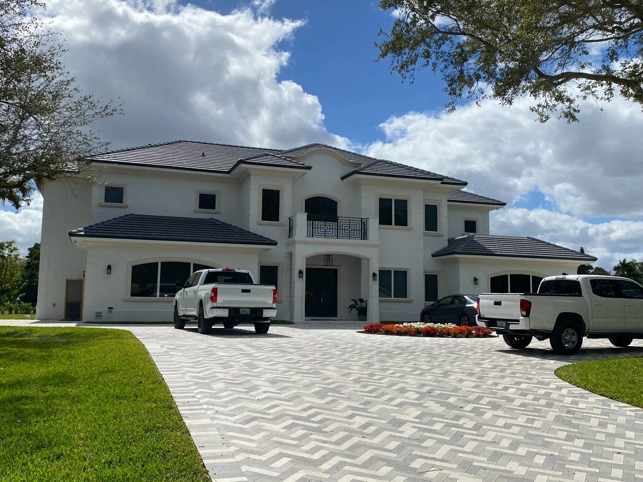 Luxury estate front entry with paved motor court and formal elevation